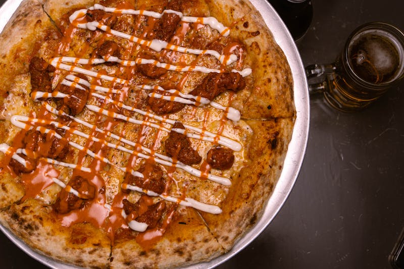 Smoky BBQ chicken pizza with ranch drizzle